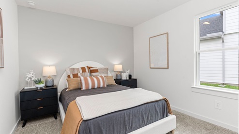 secondary bedroom with window and natural lighting