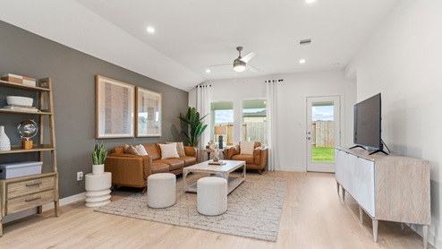 modern open concept living area with dining area and kitchen with withe cabinets