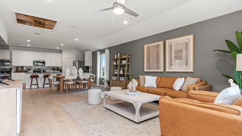 open concept living area with accent wall and natural lighting