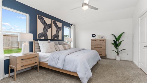 primary bedroom with open space and windows