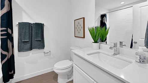 guest bathroom with tub and single sink