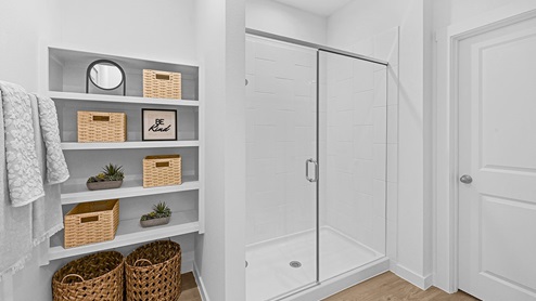 primary bathroom with shelving and stand up shower