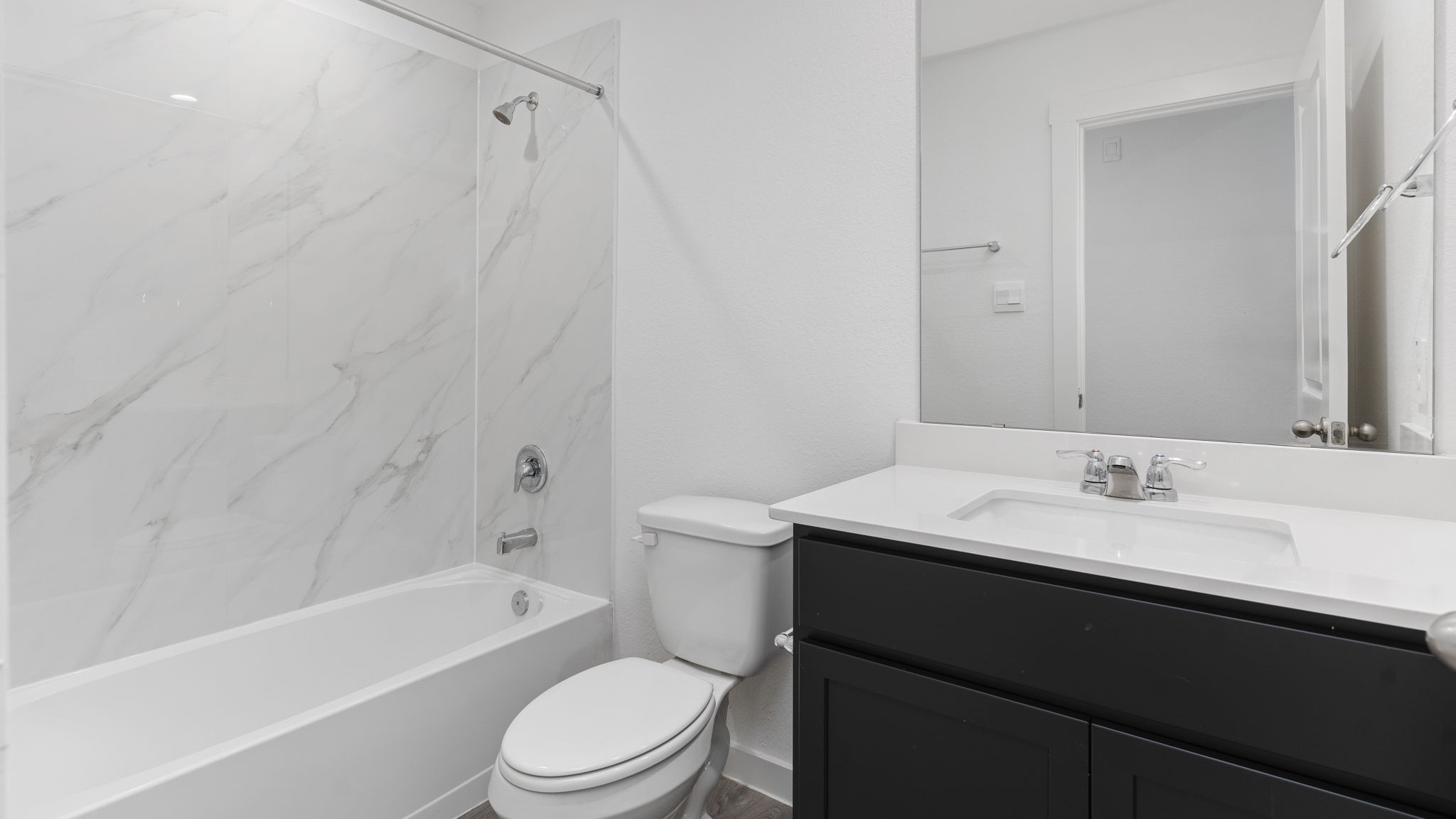 Guest bathroom with built in vanity and combination bathtub shower