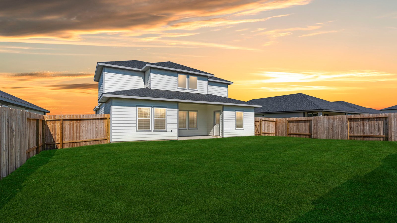 Covered back patio area overlooking private fenced-in backyard