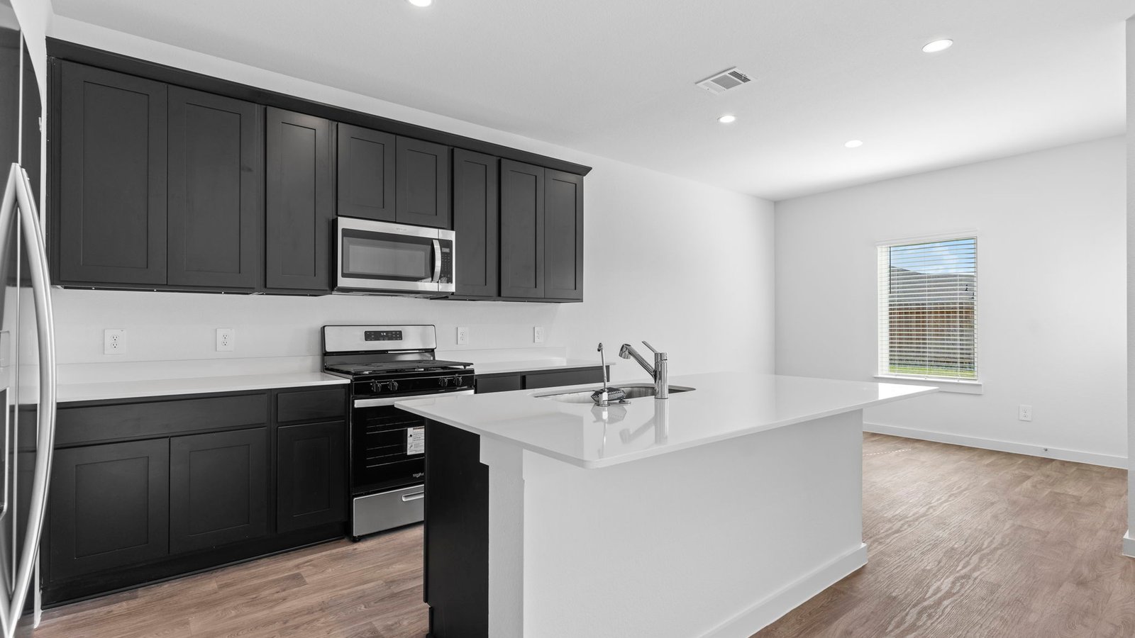 Kitchen with stainless steel appliances, shaker style cabinets, and elevated finishes