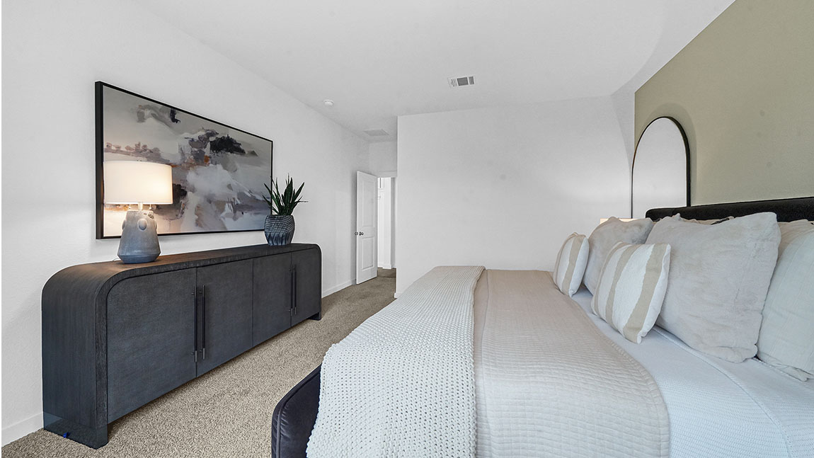 Guest bedroom 2 with side window and plush carpet floor