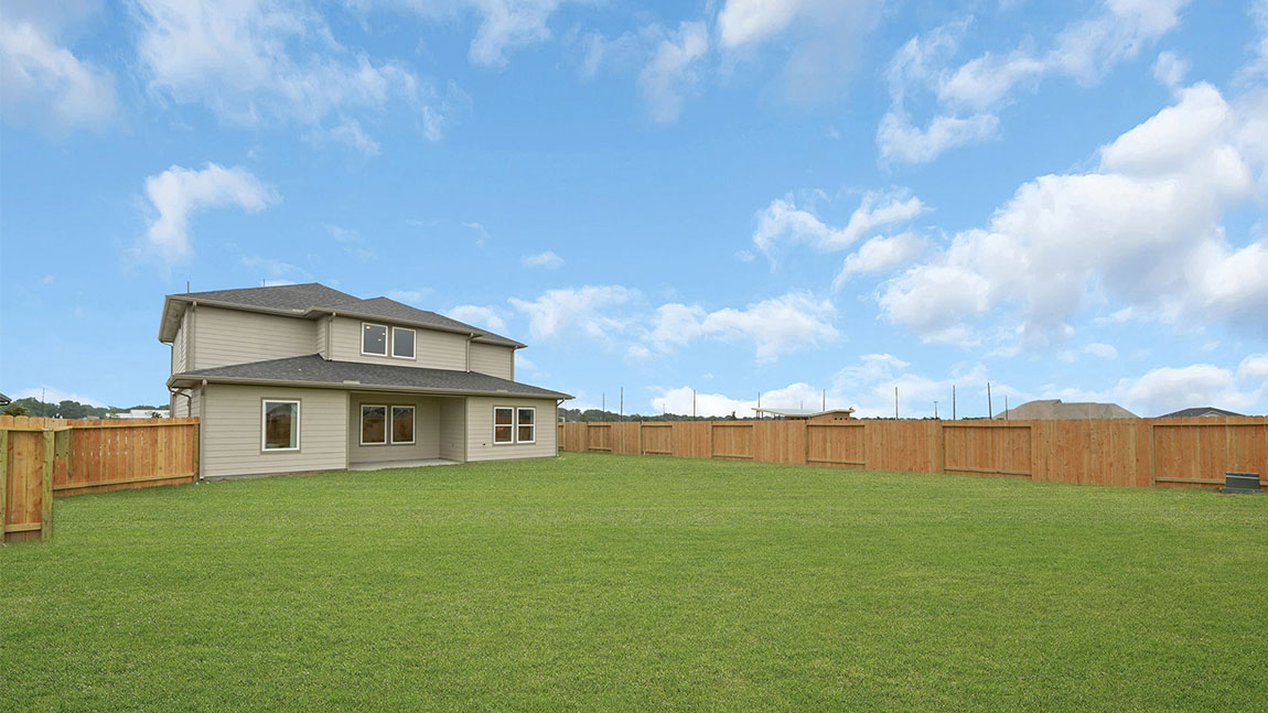 Covered back patio area overlooking private fenced-in backyard