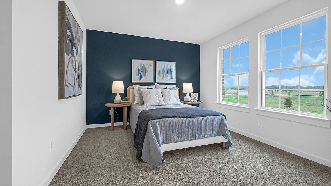 Primary bedroom with plush carpet floors and light allowing double windows