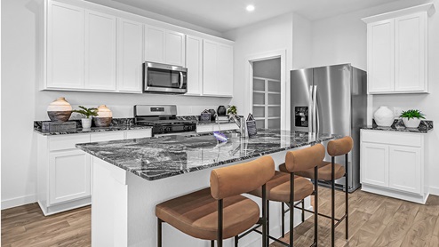 kitchen with granite countertops, white cabinets, and stainless steel appliances