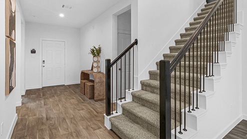 hallway leading to front door and stairs