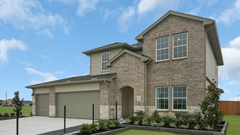 two story house with brick exterior and three car garage