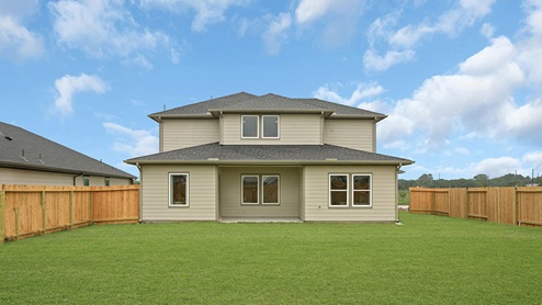 fully fenced rear yard with gate and covered patio