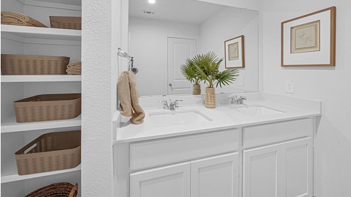 secondary bathroom with wood shelving and quartz vanity tops