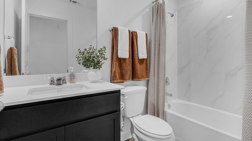 guest bathroom with tub and single vanity