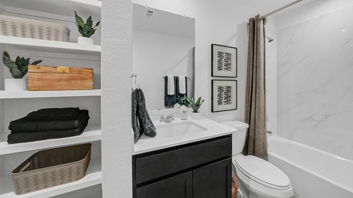 guest bathroom with storage space and tub