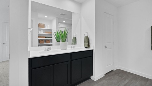 primary bedroom bathroom with dual vanities
