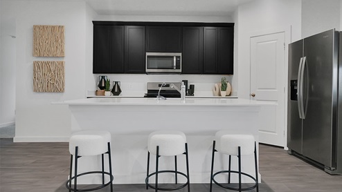 kitchen island with granite countertop and stainless steel appliances