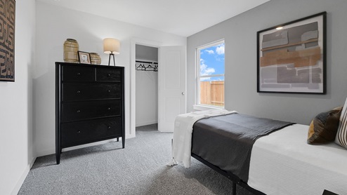 bedroom with natural lighting and spacious closet