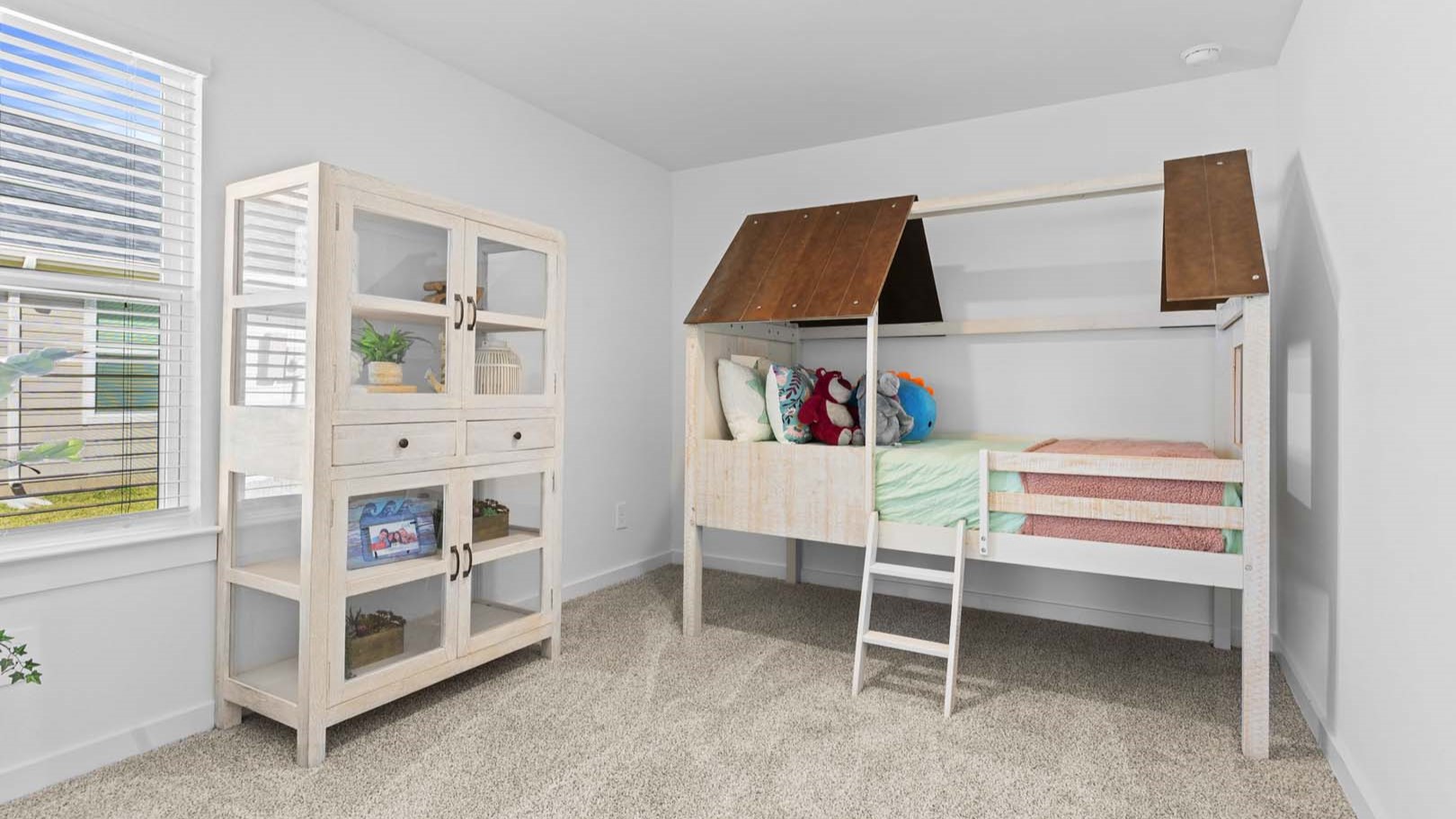 Guest bedroom 2 with side window and plush carpet floor
