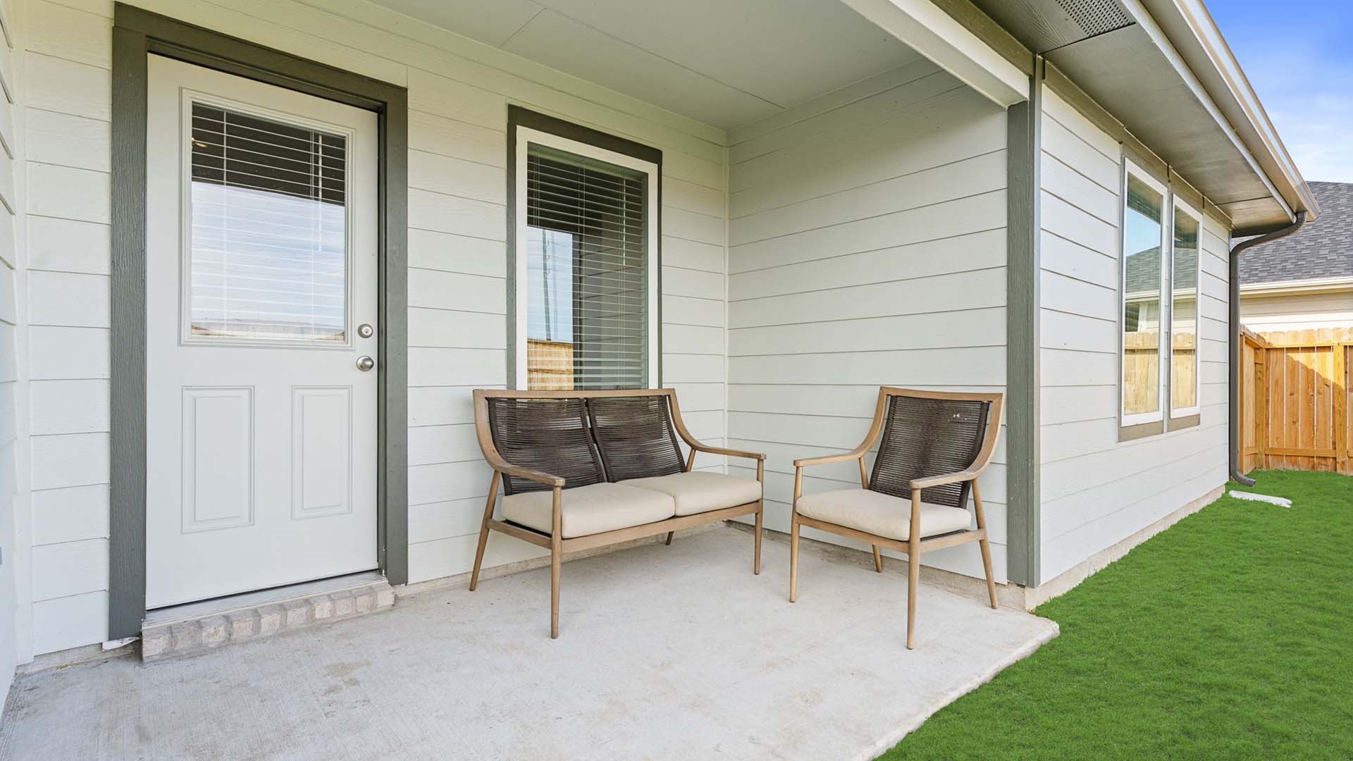 Covered back patio area overlooking spacious backyard