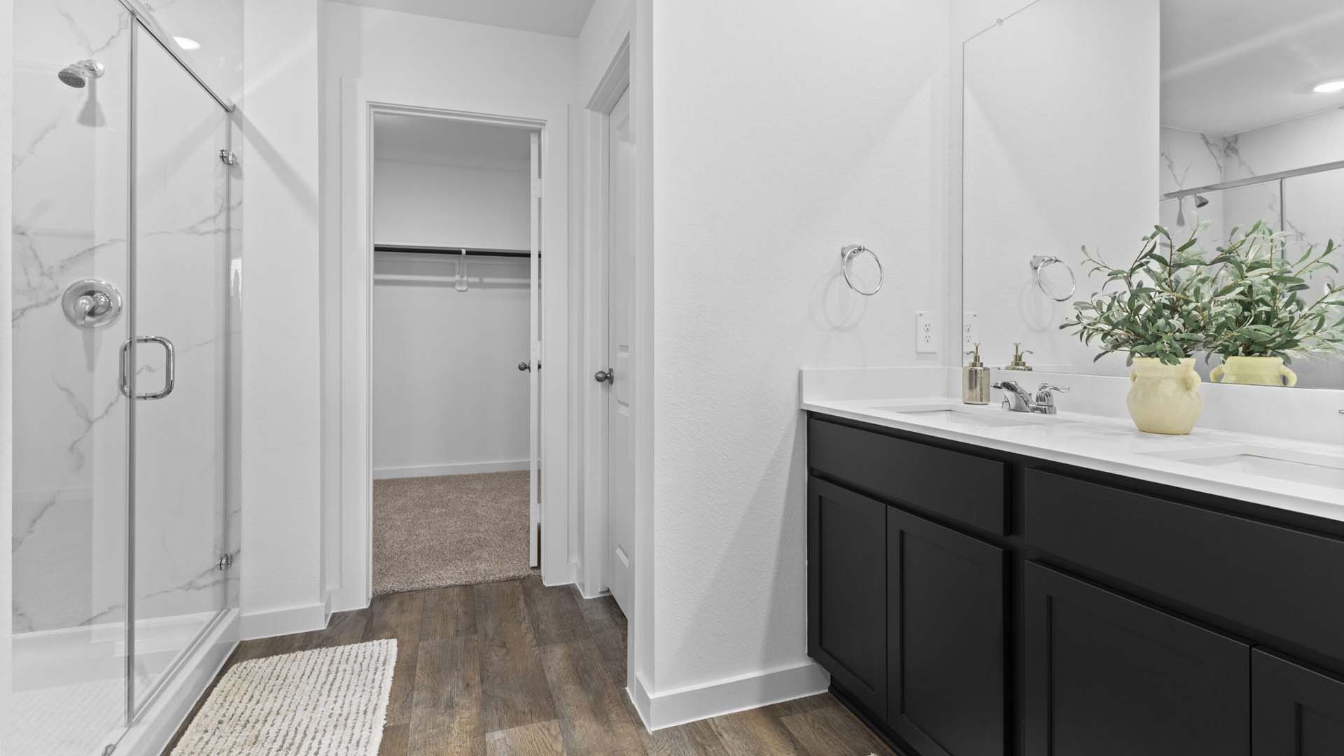 Primary bathroom with tiled shower and separate bathtub