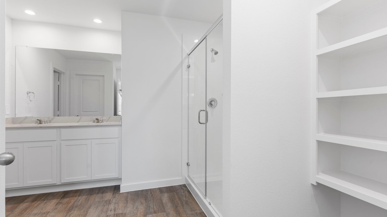 standing shower and dual sinks primary bathroom
