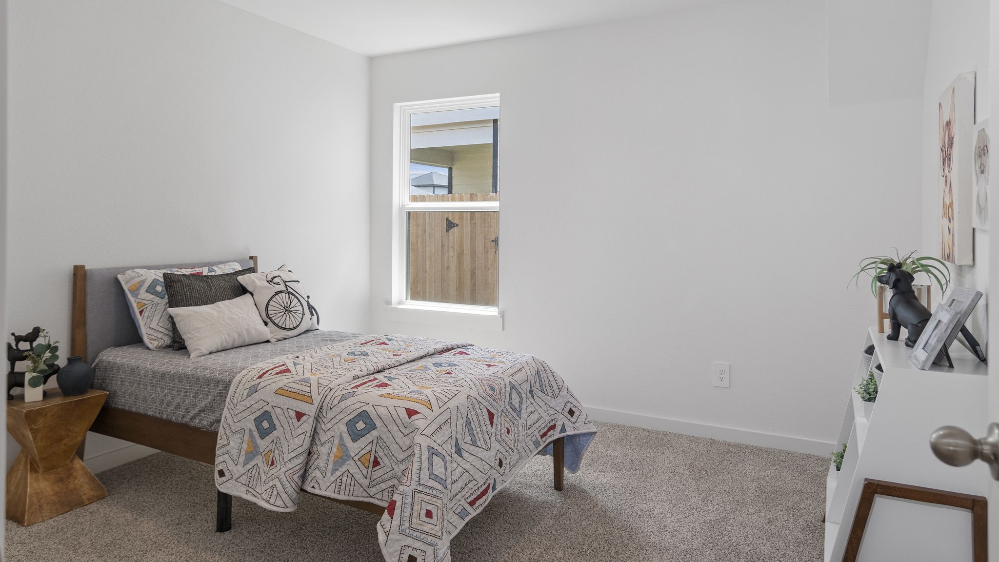Guest bedroom 2 with side window and plush carpet floor