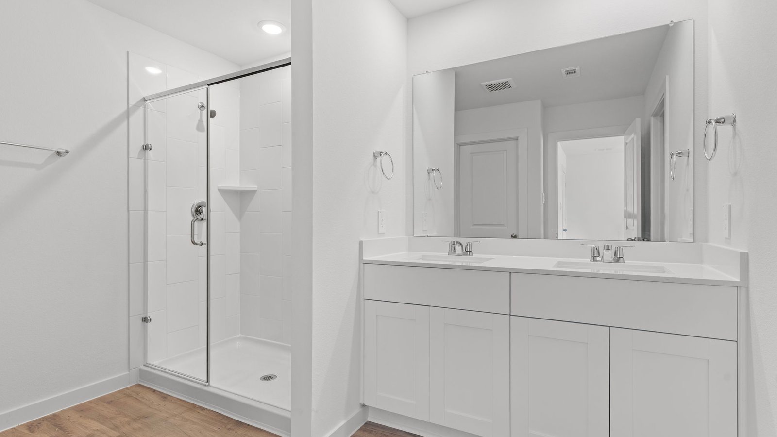 dual sinks and standing shower primary bathroom