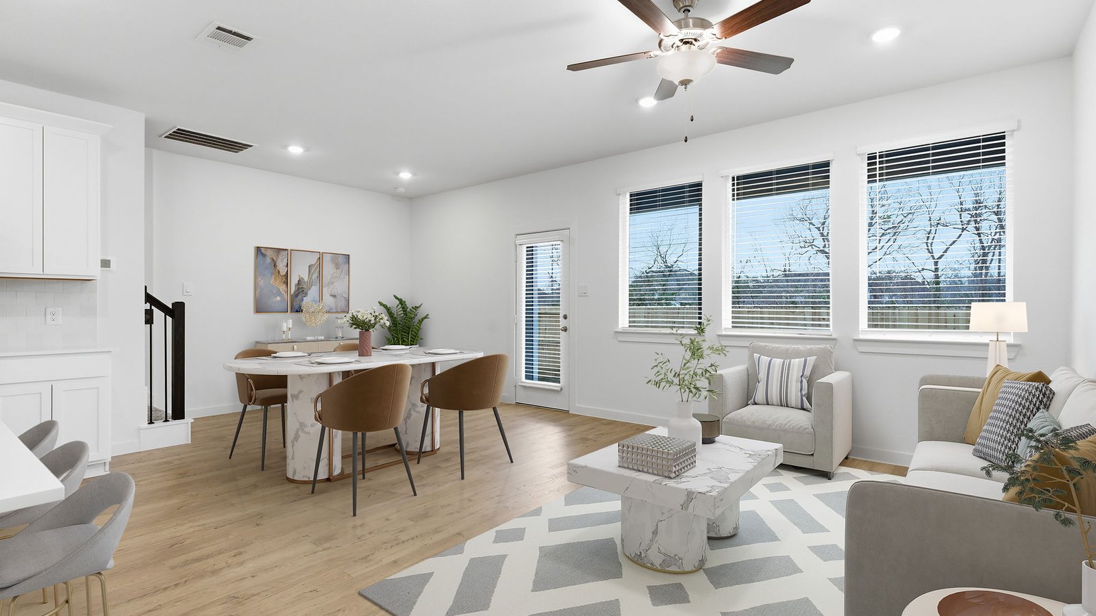 Spacious living and family room space with light allowing windows