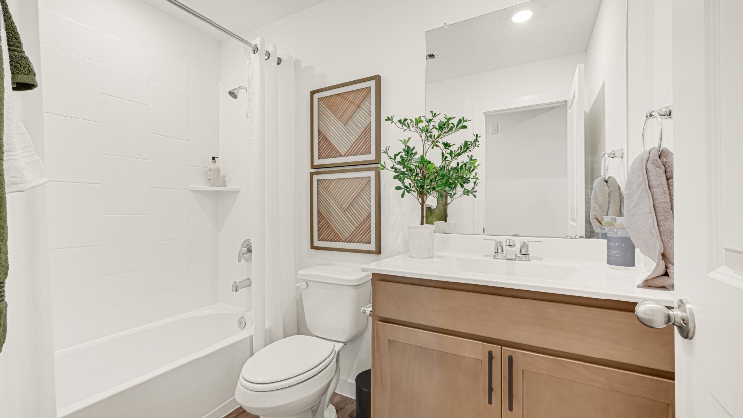 Guest bathroom with built in vanity and combination bathtub shower