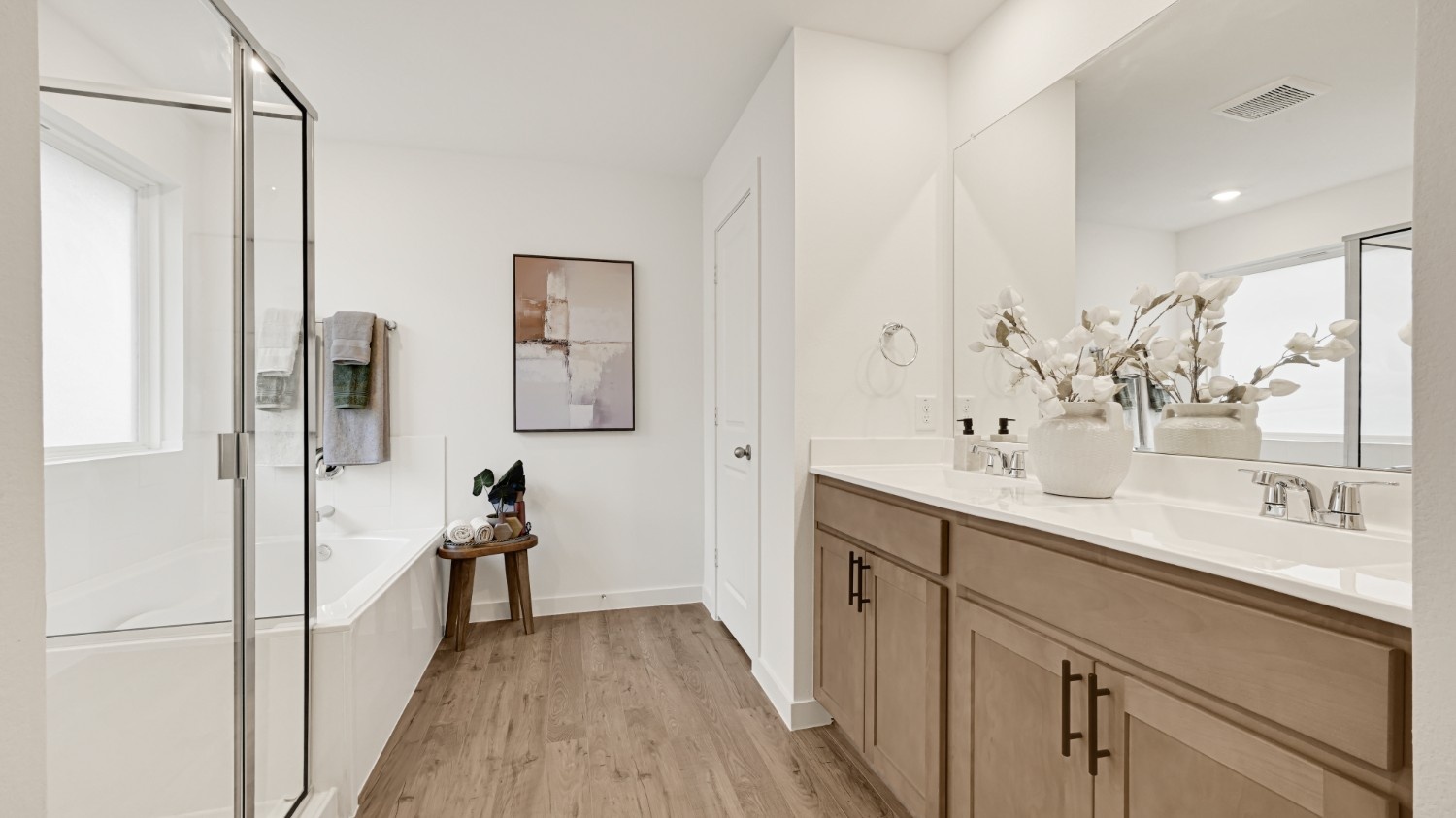 Private attached primary bathroom with built in vanity and luxurious shower
