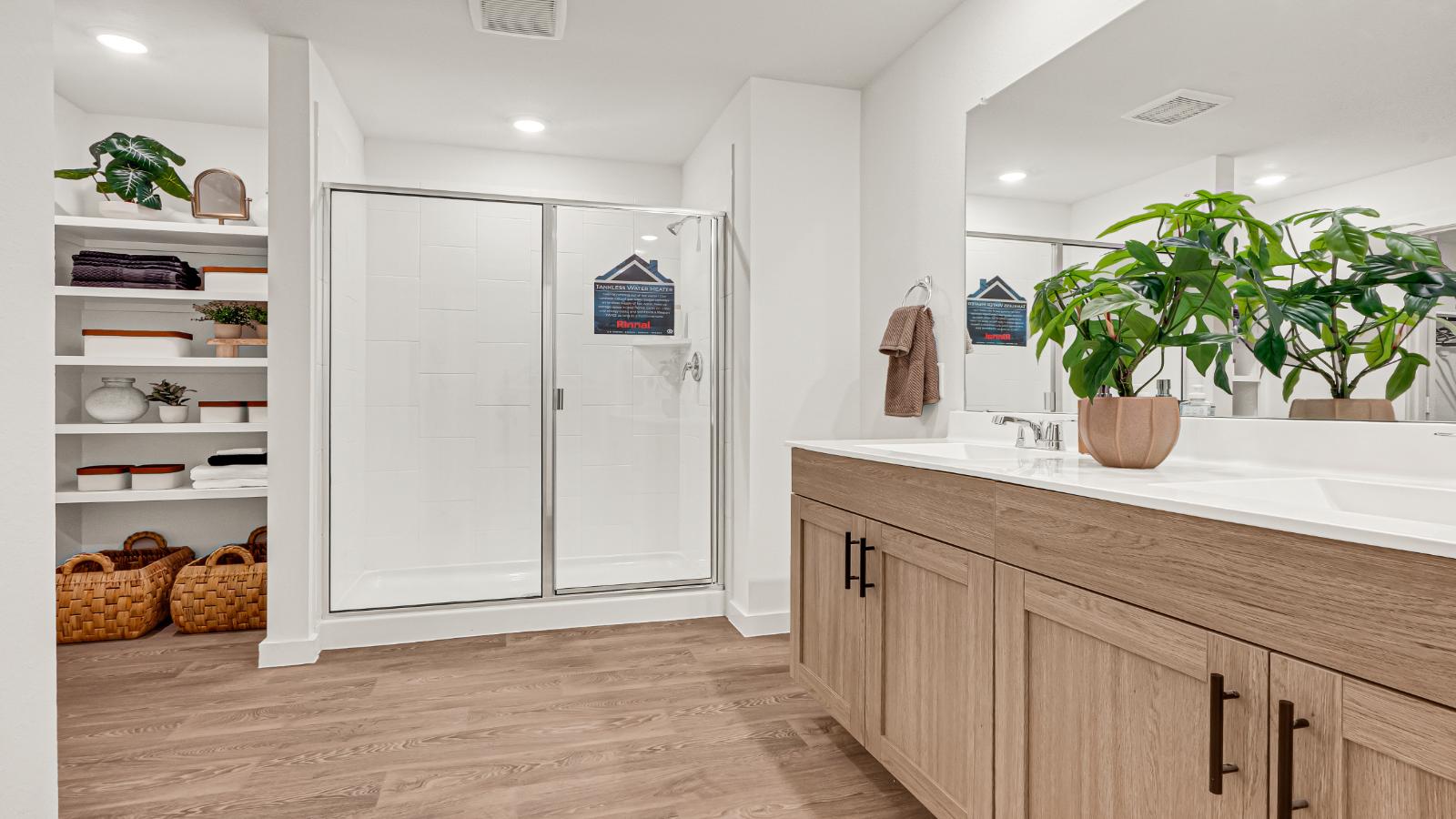 primary bathroom with dual sink and walk in closet