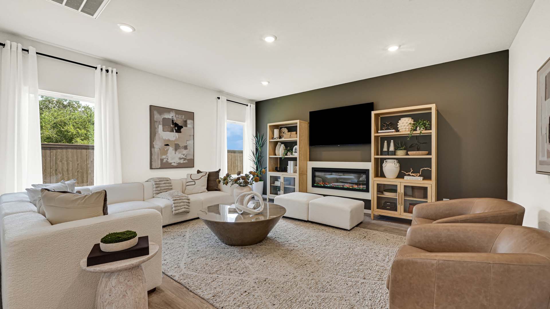 Spacious living and family room space with light allowing windows
