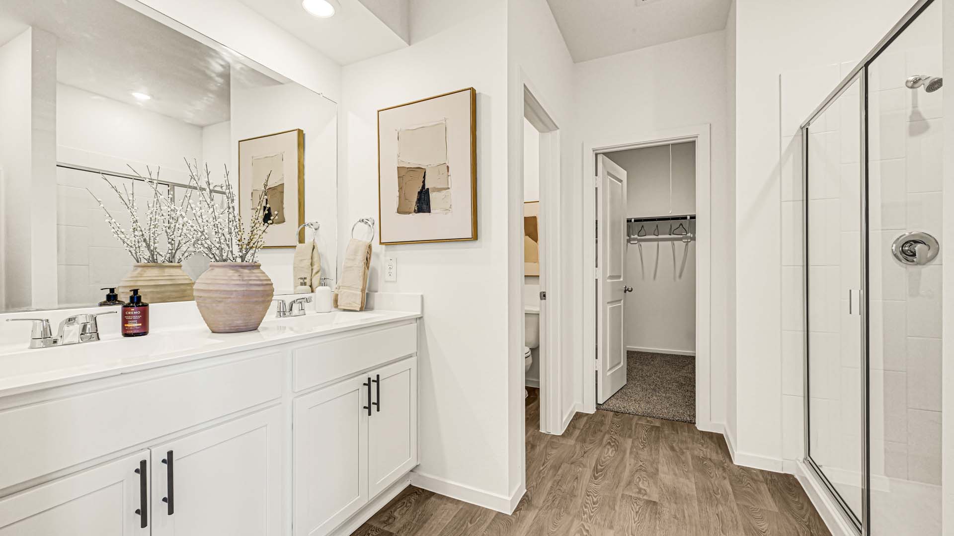 Private attached primary bathroom with built in vanity and luxurious shower