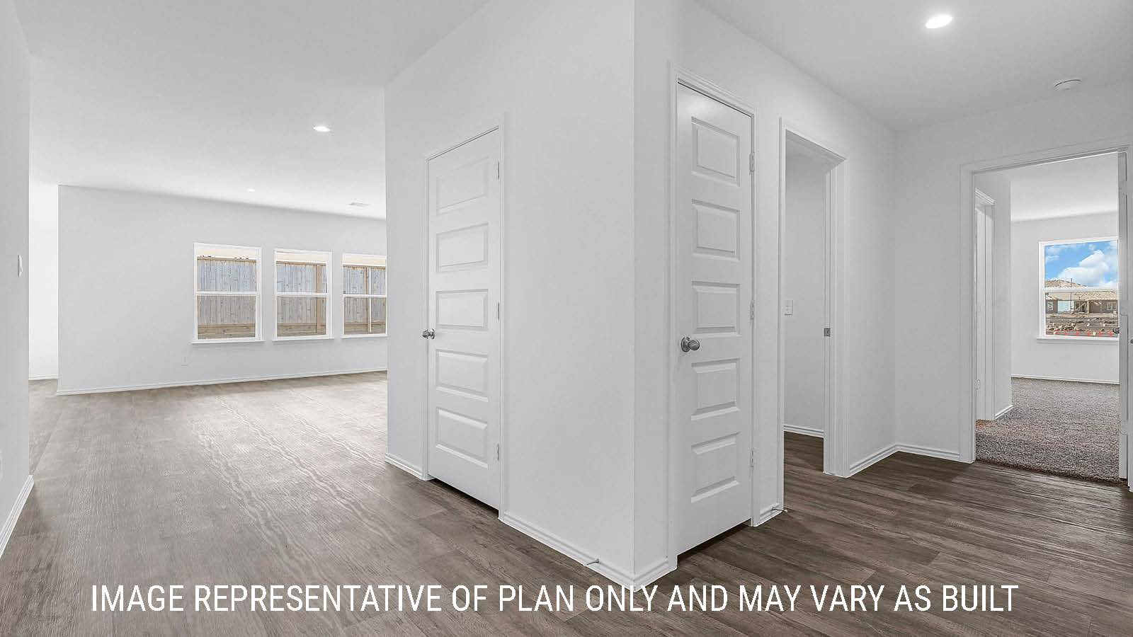 Fairfield hallway with view vinyl plank flooring and view of living room and bedroom.