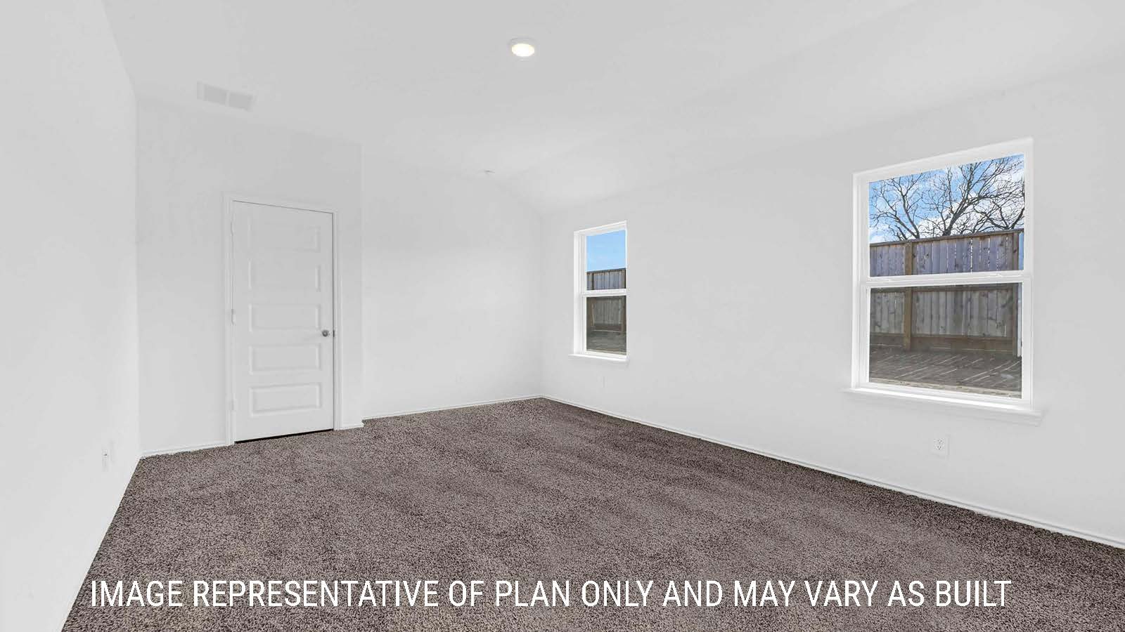 Fairfield primary bedroom with carpeted flooring and windows for natural lighting.