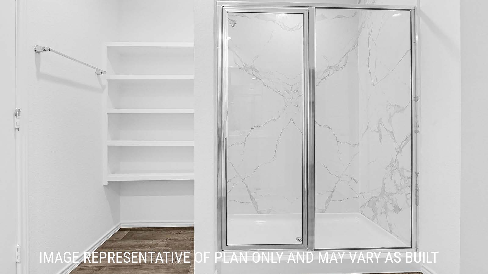 Fairfield primary bathroom with walk-in shower and shelving for storage.