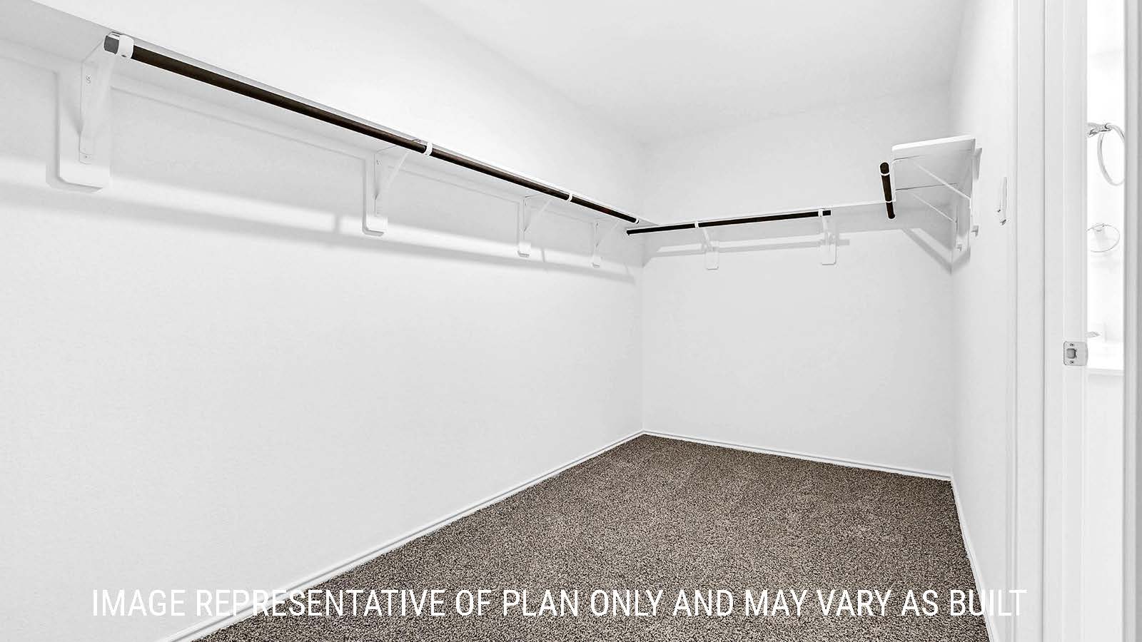 Fairfield primary closet with carpeted flooring and shelving for storage.