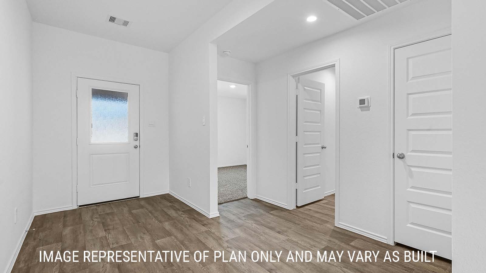 Fairfield front hallway with vinyl plank flooring and view of front door.