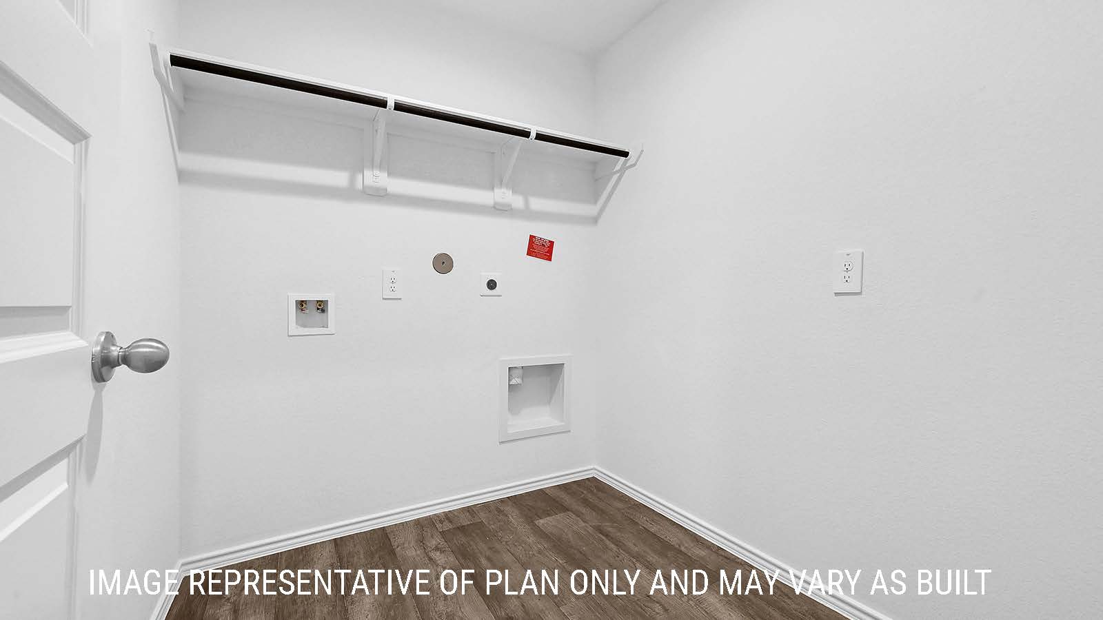 Fairfield utility room with washer and dryer connections and shelving for storage.