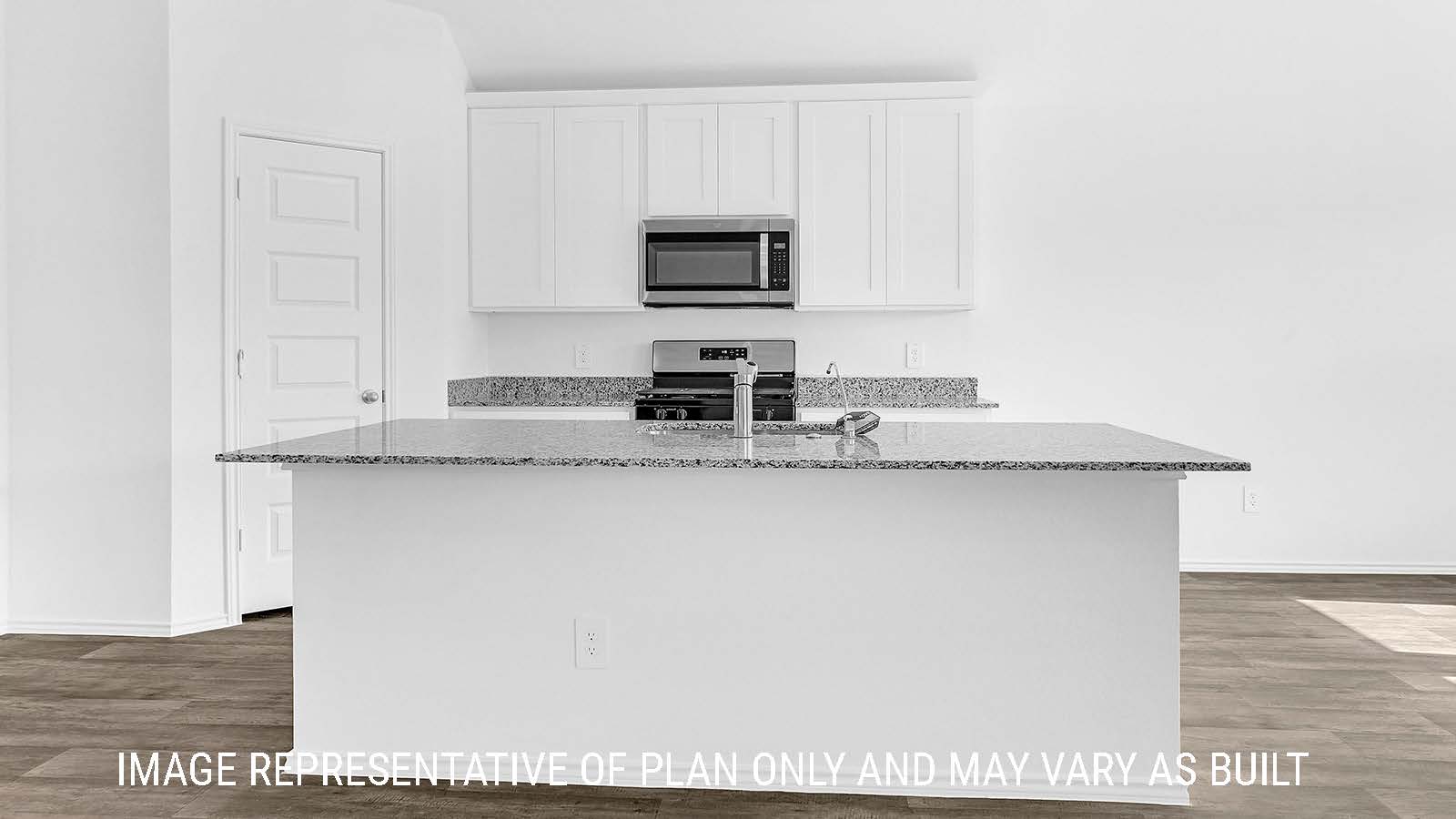 Fairfield kitchen with kitchen island and white cabinets with granite countertops.