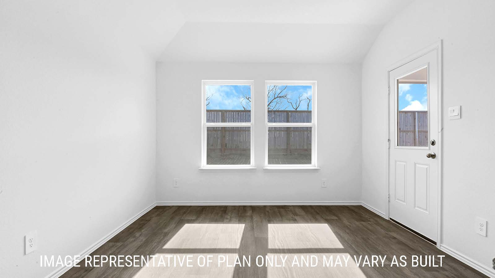 Fairfield dining room with vinyl plank flooring and view of back door to the backyard.