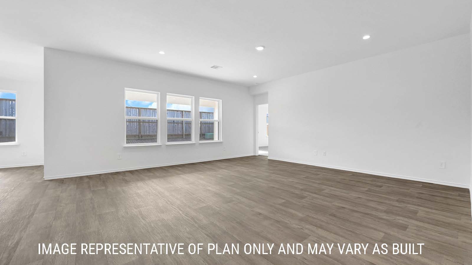 Fairfield living room with vinyl plank flooring and windows for natural lighting.