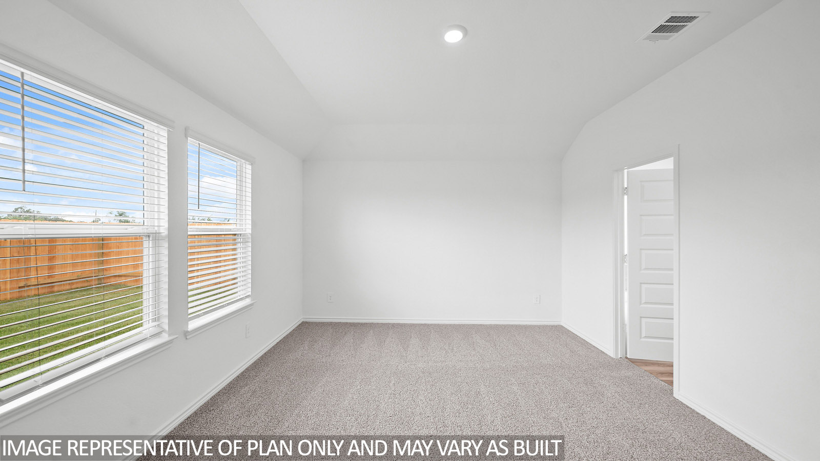 Harris primary bedroom with carpet flooring and windows to backyard.