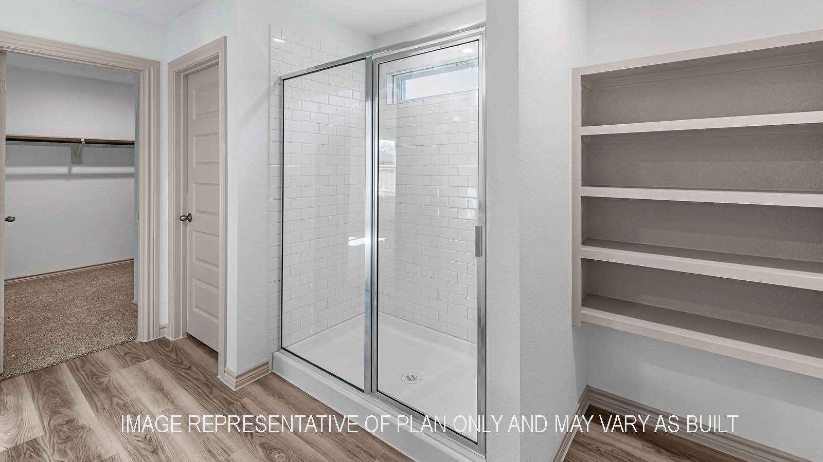 Camden primary bathroom with walk-in shower and view of walk-in closet.
