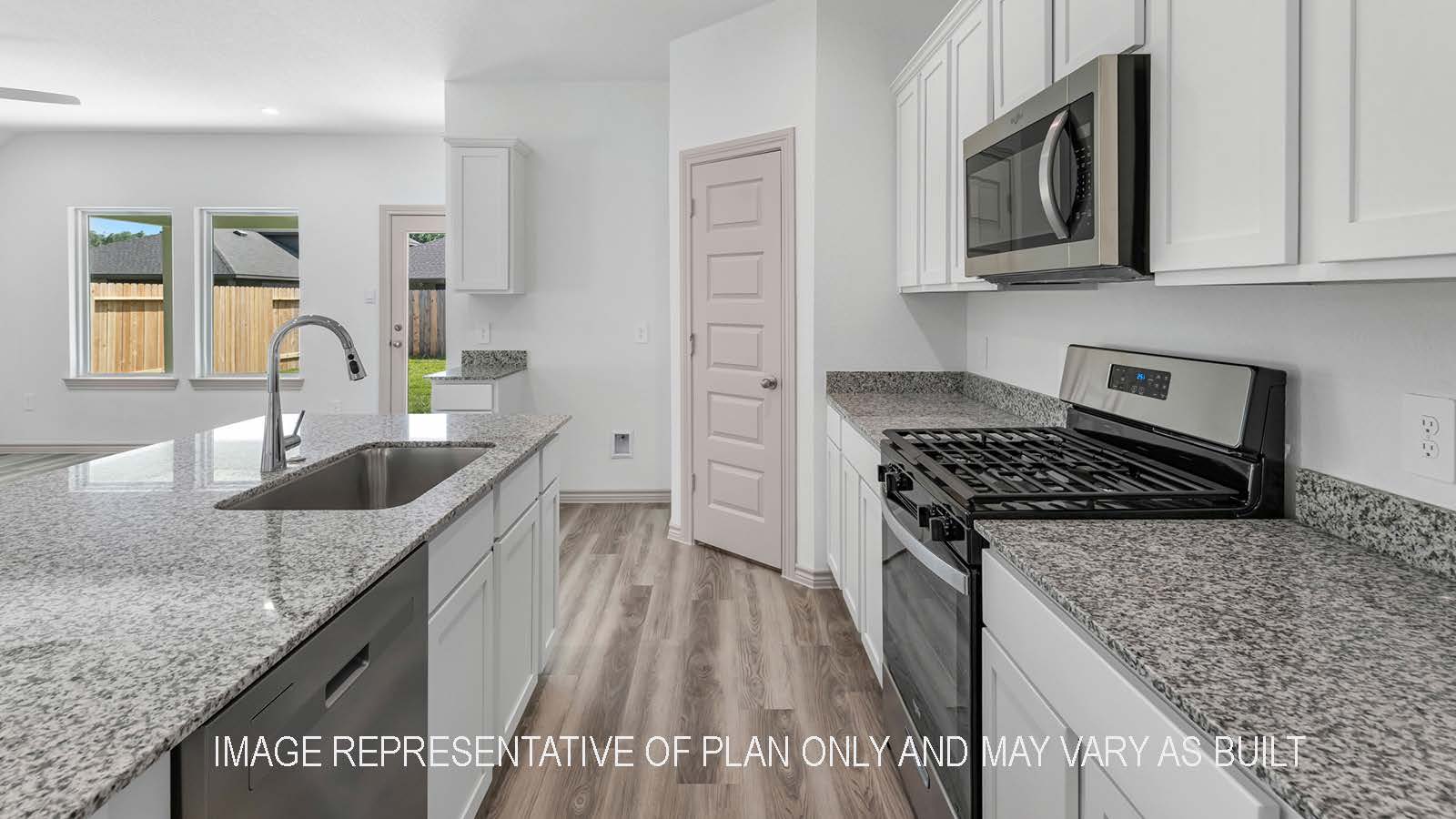 Camden kitchen island with granite countertops and view of secondary bedroom.