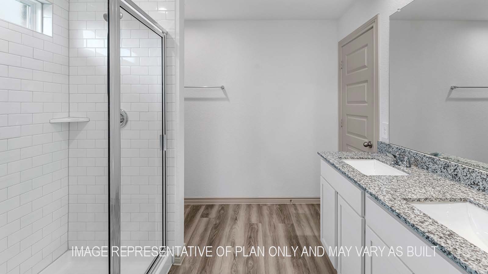 Camden primary bathroom with dual vanity sinks and walk-in shower.