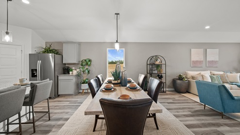 Reserve at Mallard Lakes model home open concept dining room with traditional furnishing.
