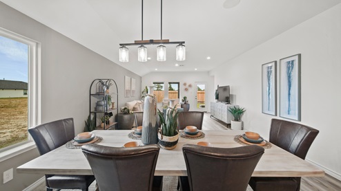 Reserve at Mallard Lakes model home open concept dining room with pendant light fixture.