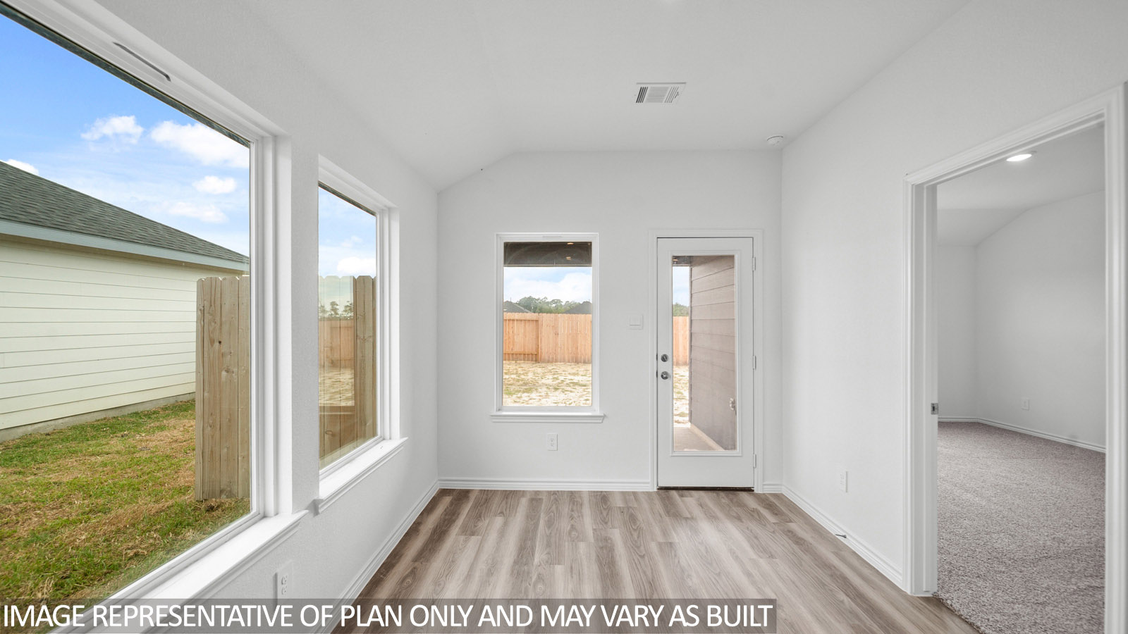 Baxtor dining room with vinyl plank flooring and view to backyard.